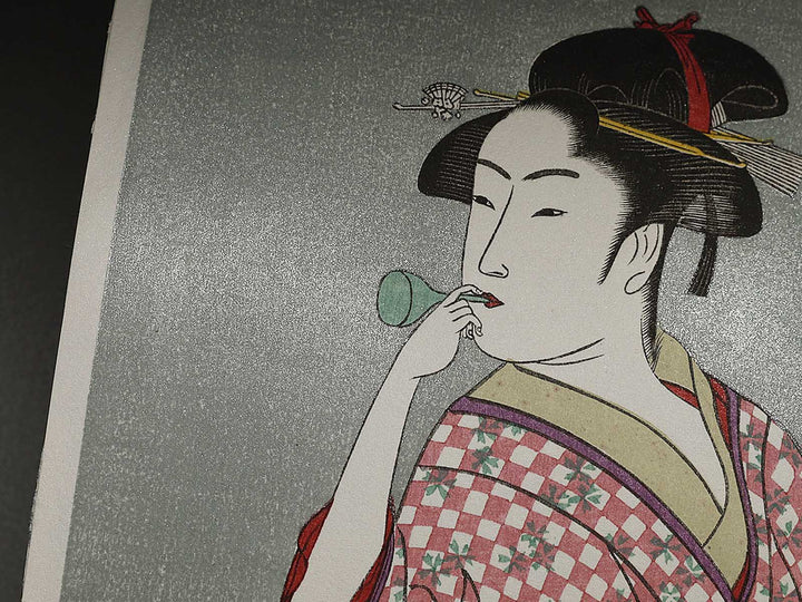 Young Woman Blowing a Popen (glass noisemaker) from the series Ten Classes of Women’s Physiognomy by Kitagawa Utamaro, (Small print size) / BJ335-909